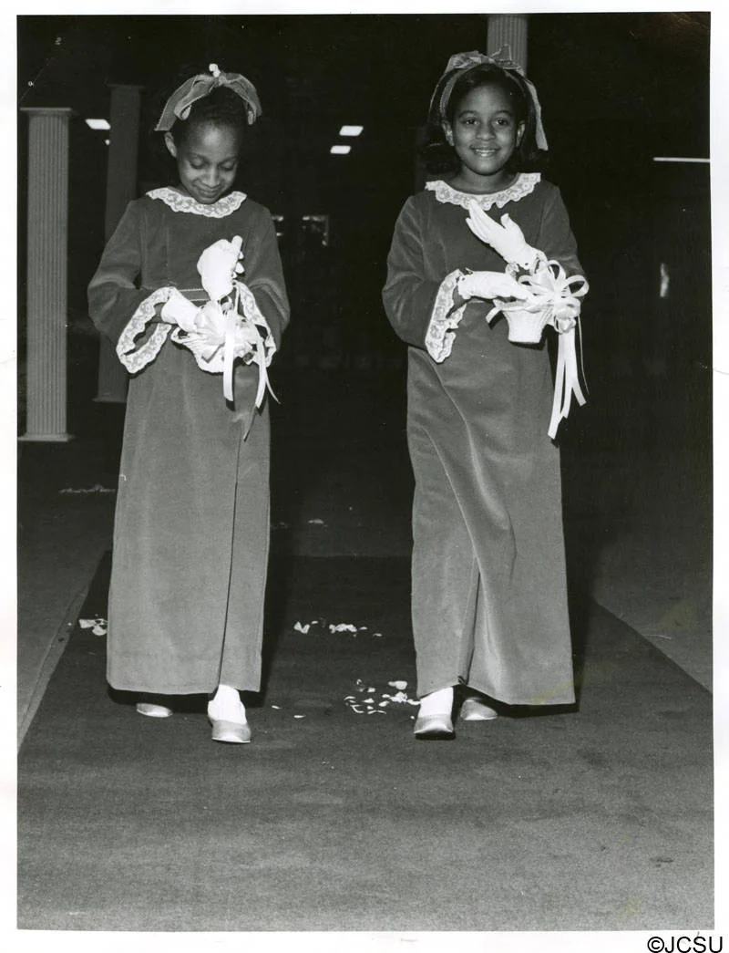 Attendants walking the aisle at a Homecoming coronation